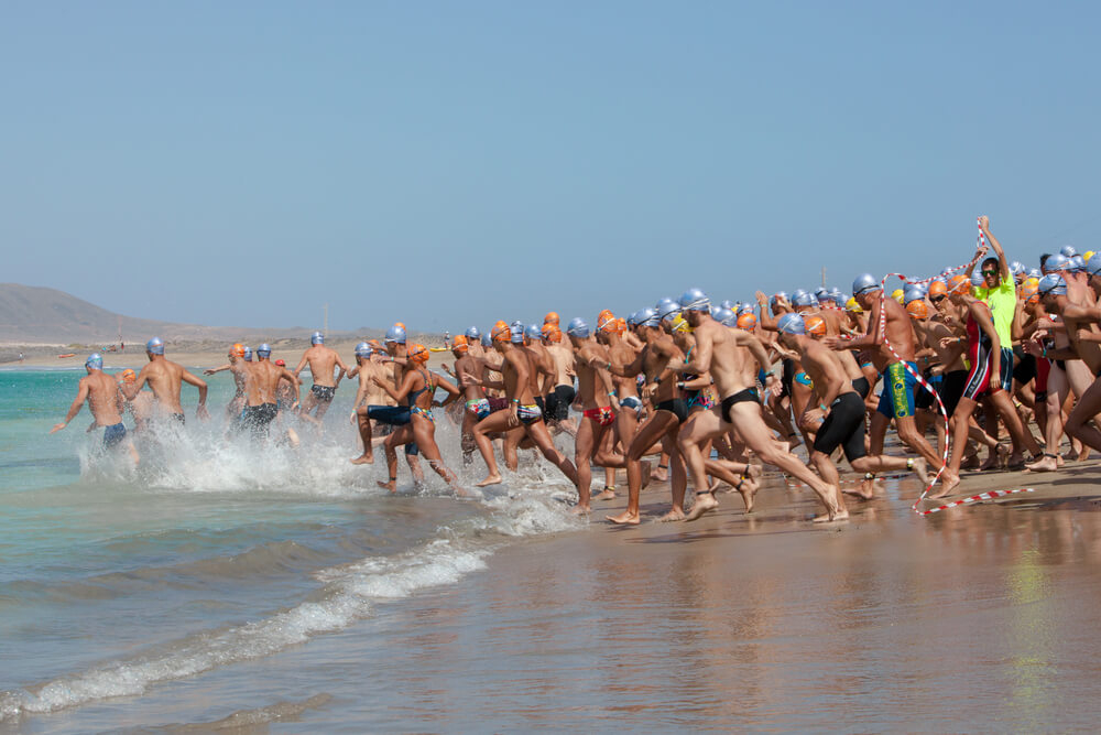 Ironman: A group of sportsmen running into the sea