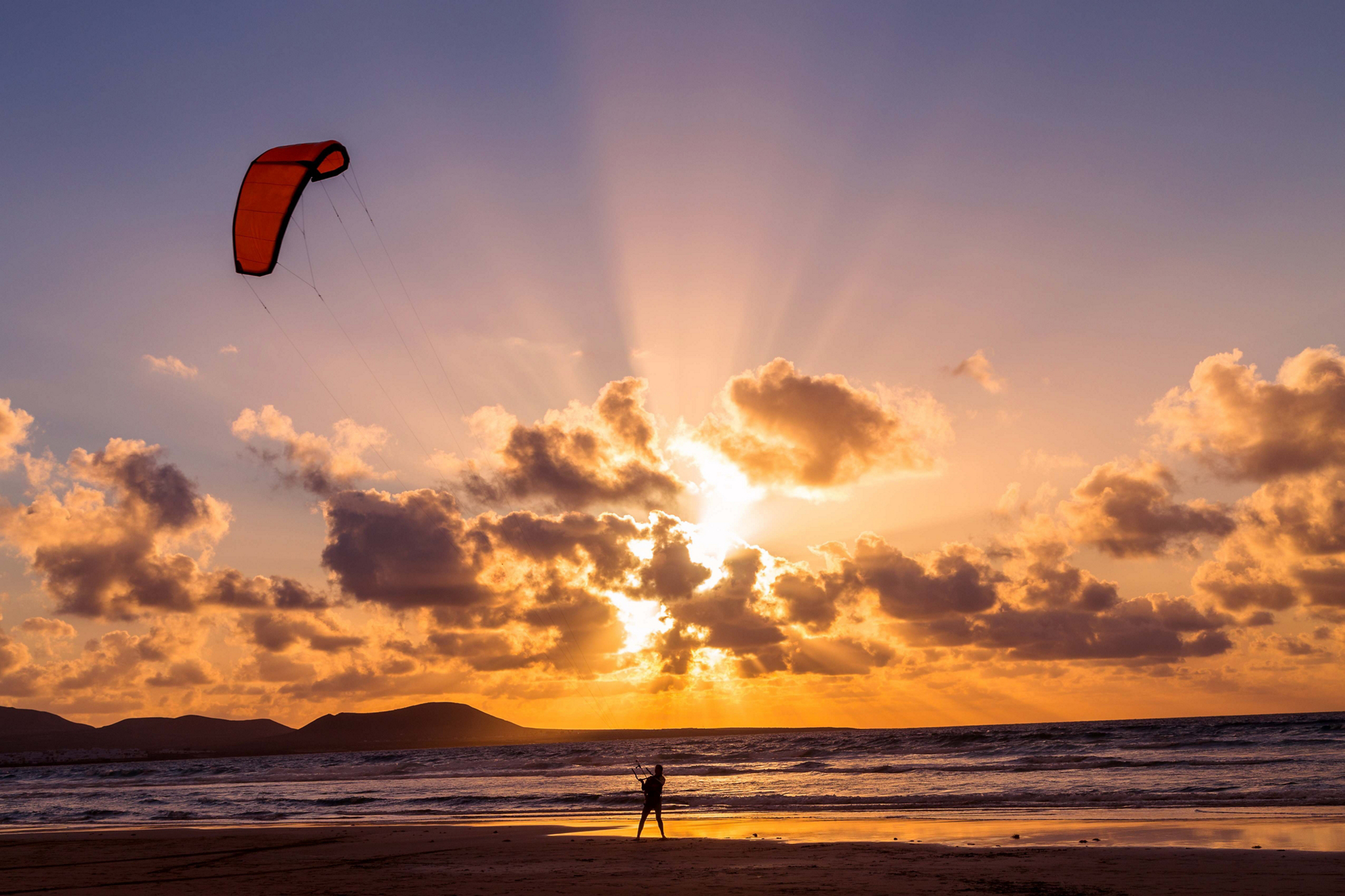 Activity holidays Lanzarote: A person kite surfing at sunset