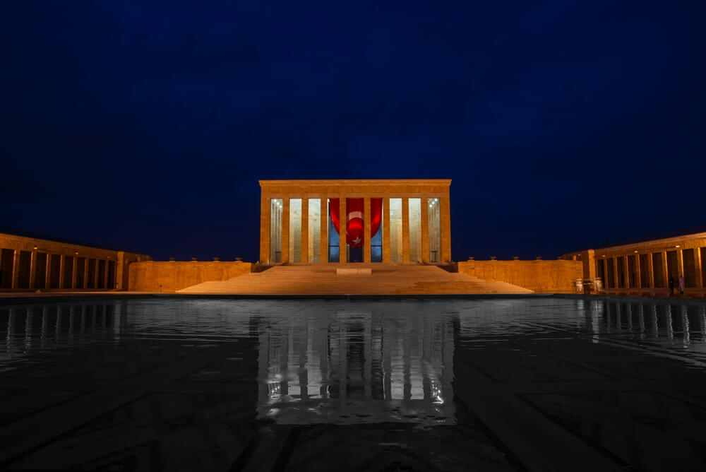 Ankara tourist attractions: A view of the Anıtkabir mausoleum lit up at night with the Turkish flag
