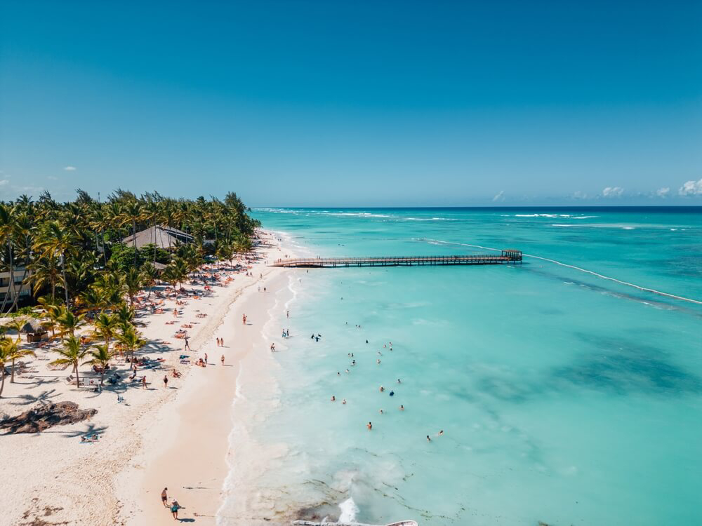 A long pier stretches out over the waters of this beautiful beach in the Dominican Republic.