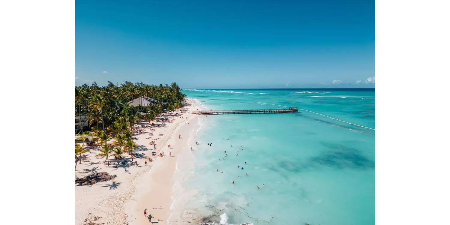 A long pier stretches out over the waters of this beautiful beach in the Dominican Republic.