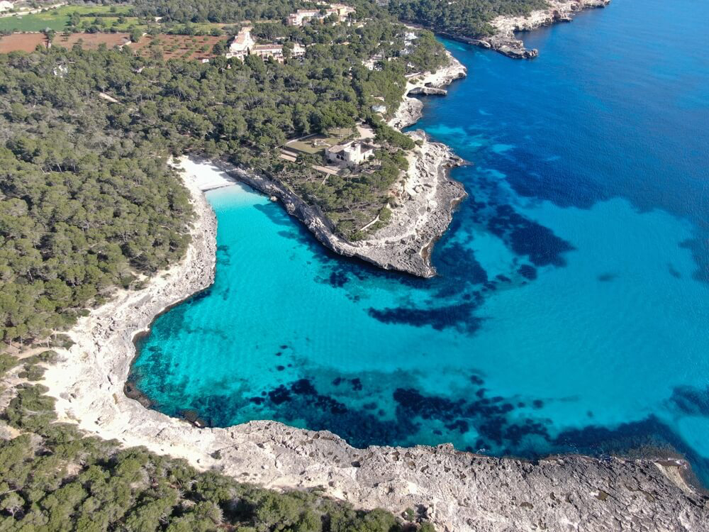 Best beaches in Mallorca: A bird’s eye view of the white sand cove of Cala Mondragó