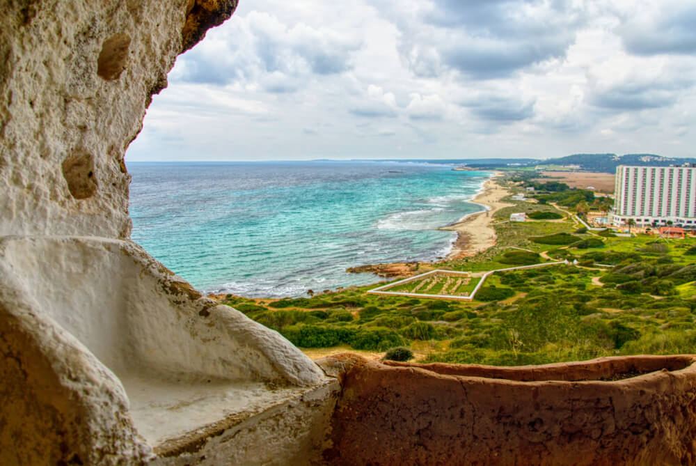 Best quiet beaches in Menorca: Playa Son Bou seen from the caves above