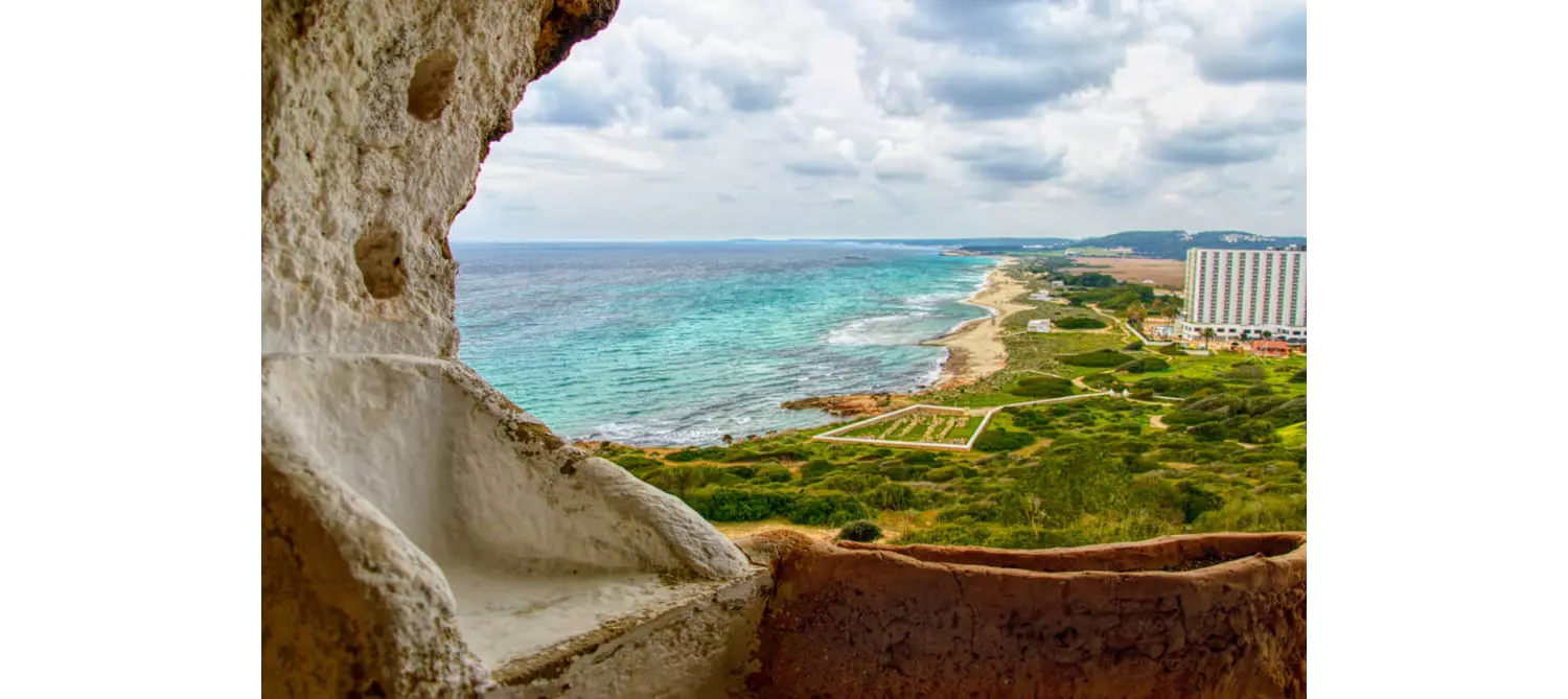 Best quiet beaches in Menorca: Playa Son Bou seen from the caves above