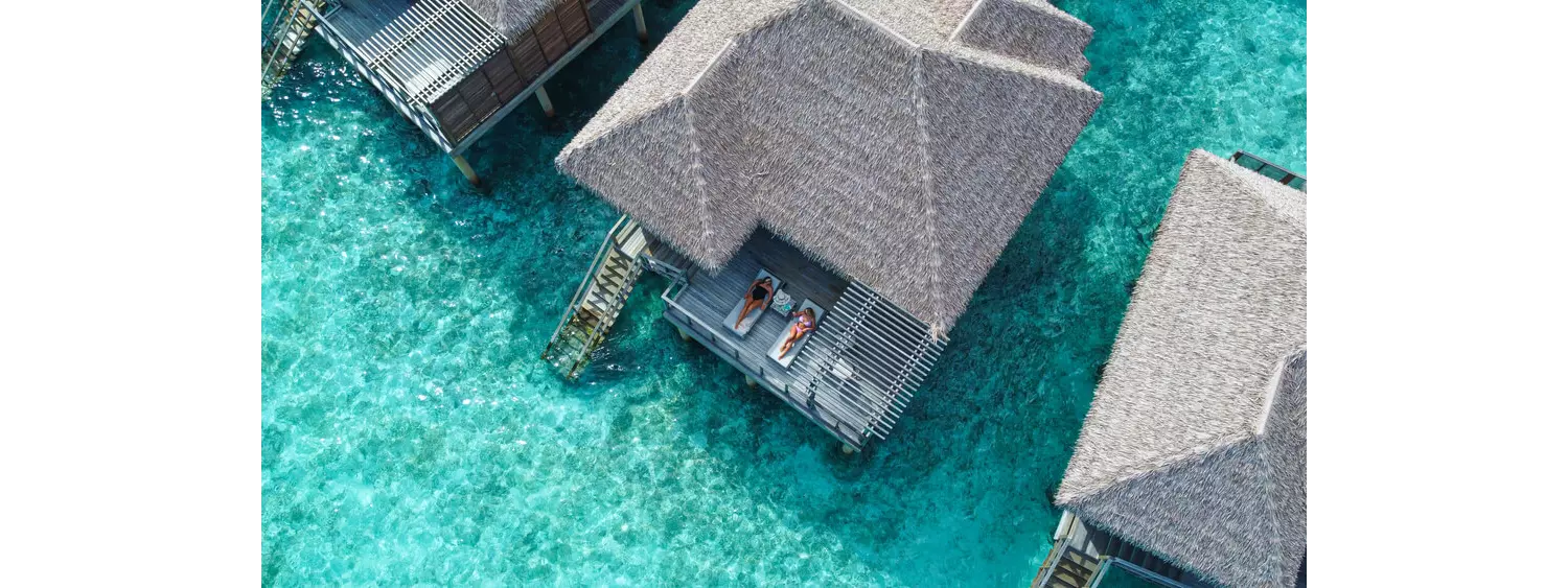 Best honeymoon destinations: A Maldives ocean villa with a couple on the terrace