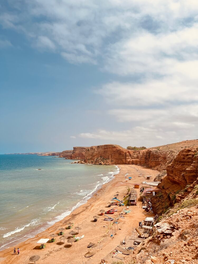 Agadir: A golden coastline seen from above with people in the sea