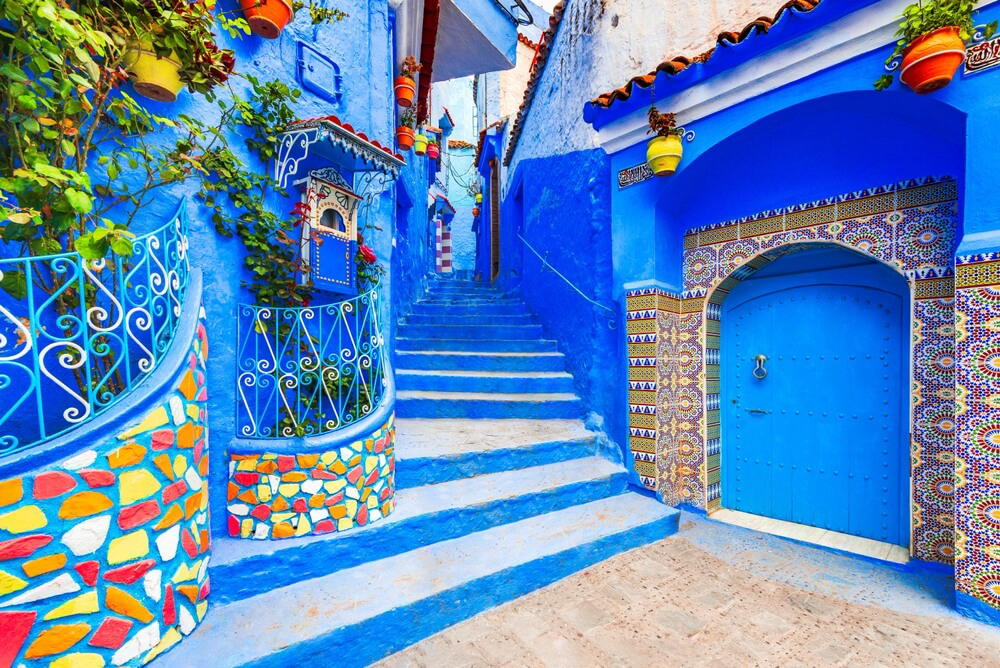 Chefchaouen: A blue building and stairway with decorative motifs