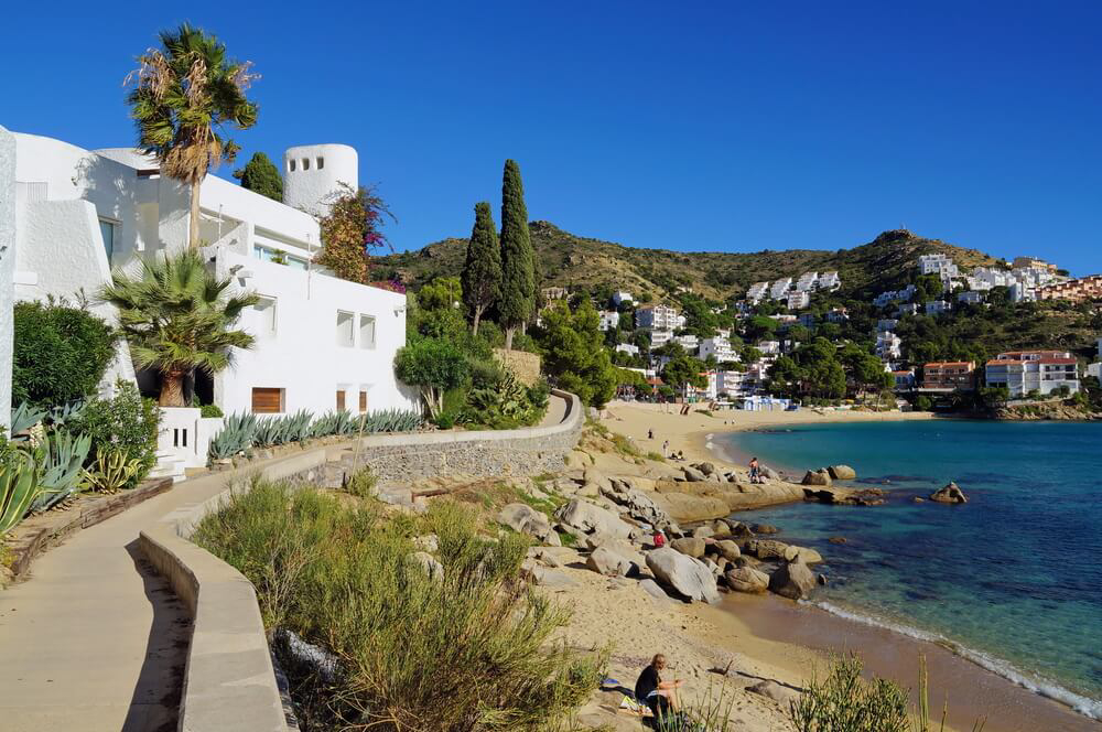 Best summer holiday destinations: A stone walkway with white houses and the sea