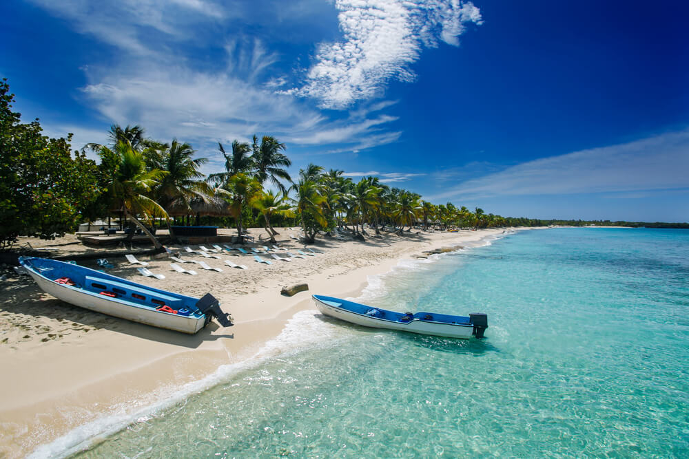 Black Friday travel deals: Beach in Punta Cana with boats on the white sand