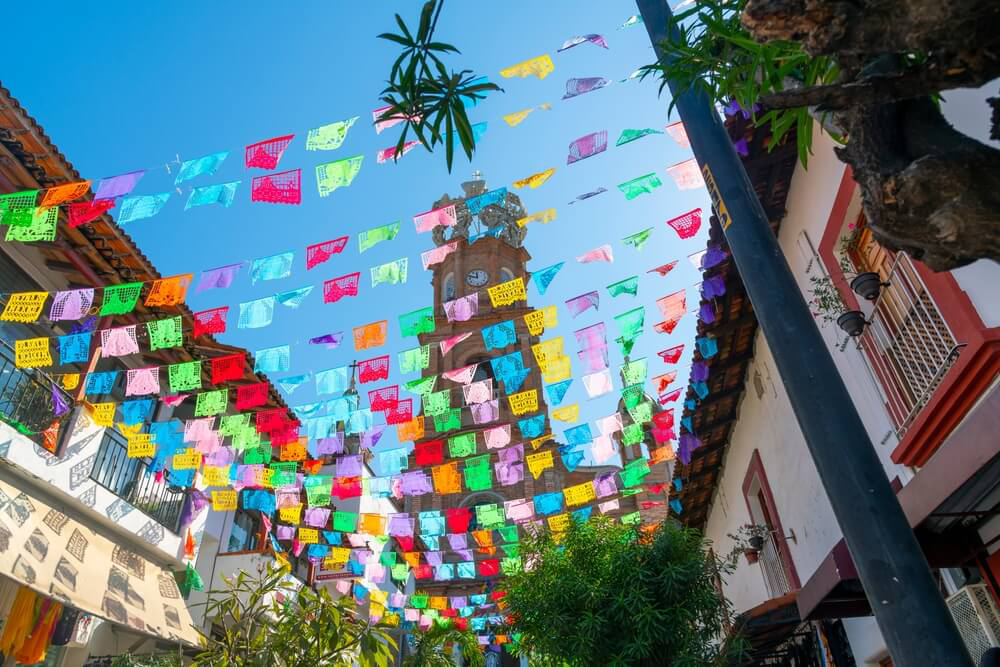 Colorful flags decorate a street in Puerto Vallarta.