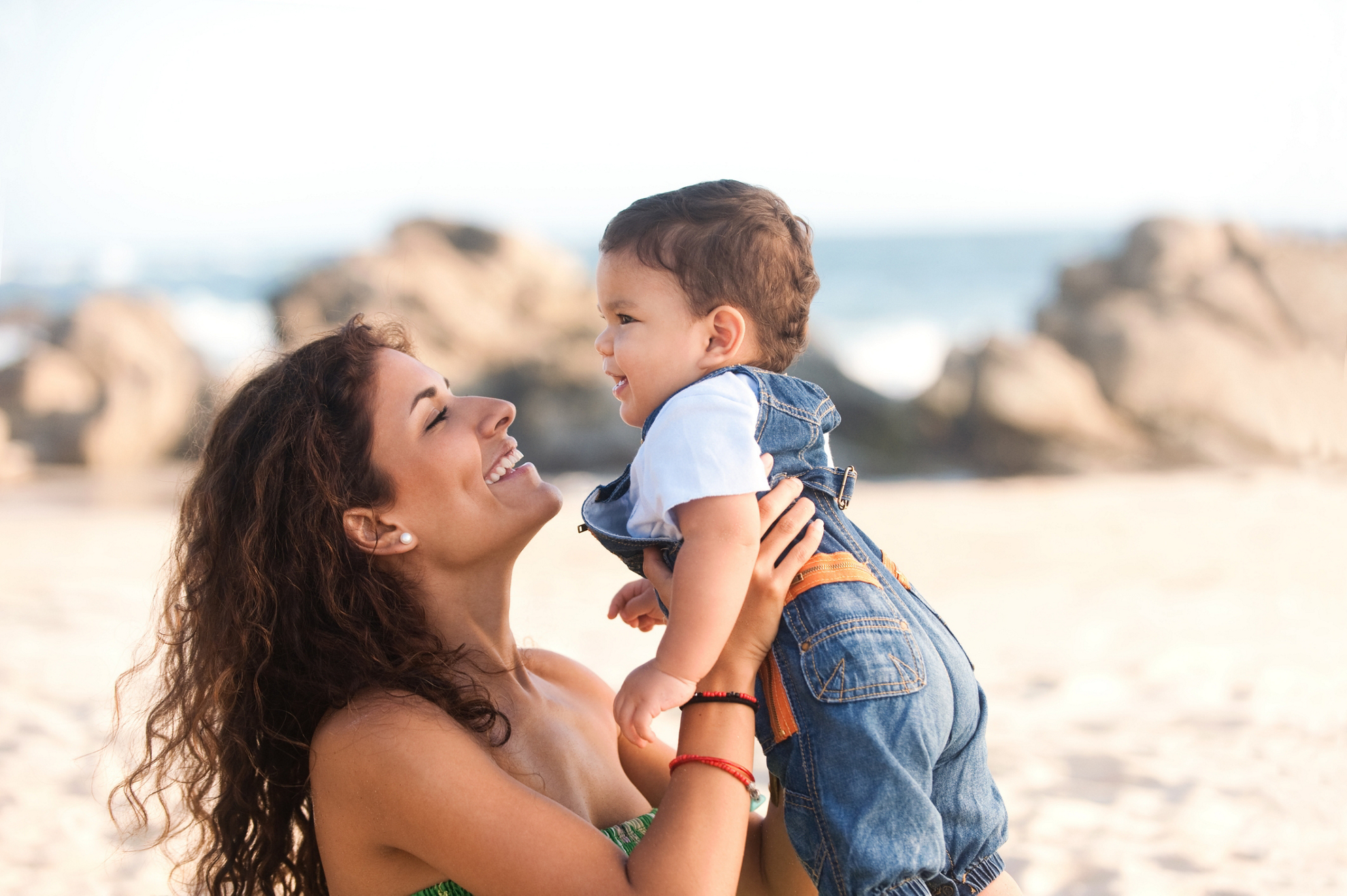 Happy mother with her son enjoying the beach