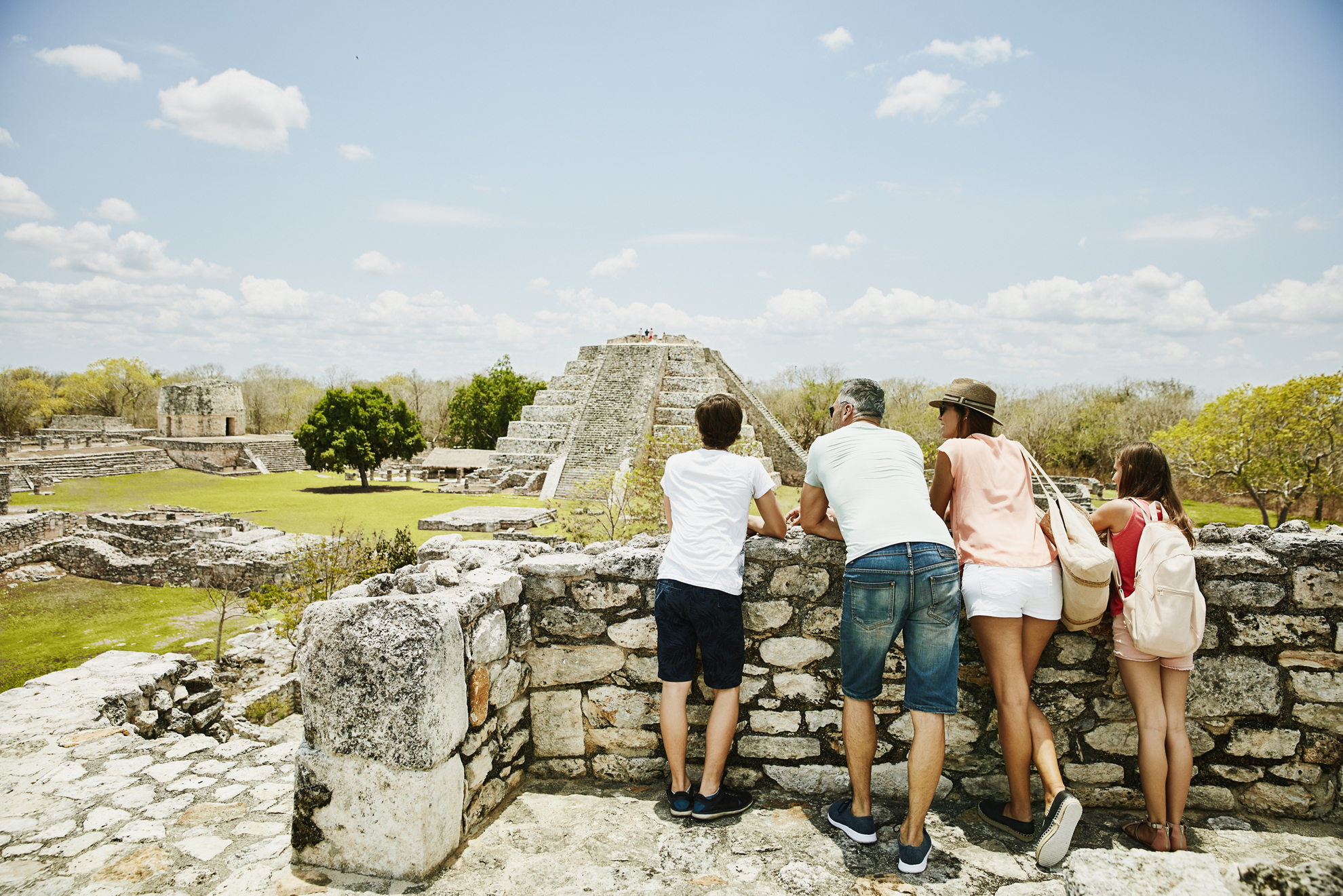 Family looking at view while exploring ruins at Mayapan during vacation
