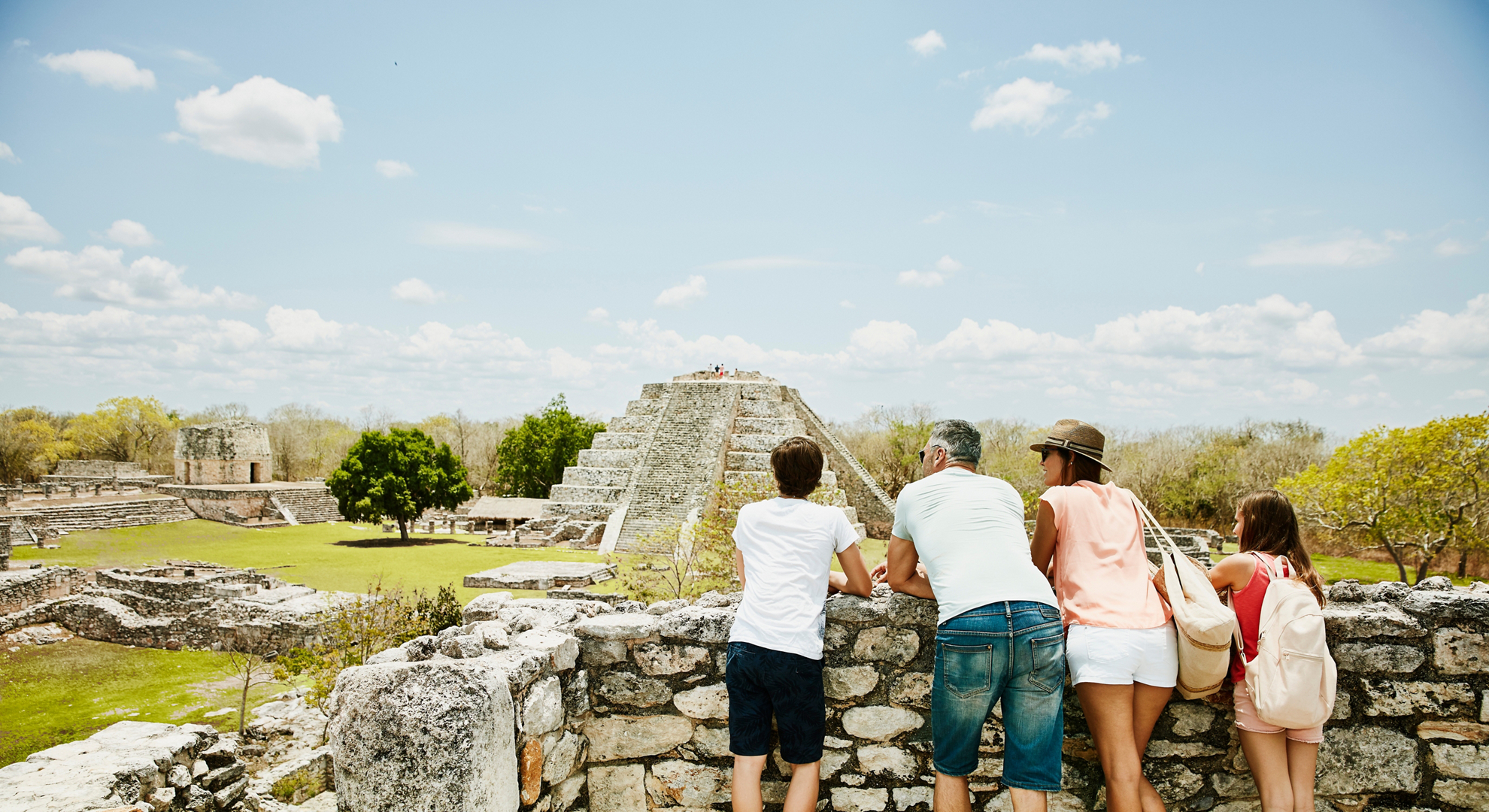 Family looking at view while exploring ruins at Mayapan during vacation
