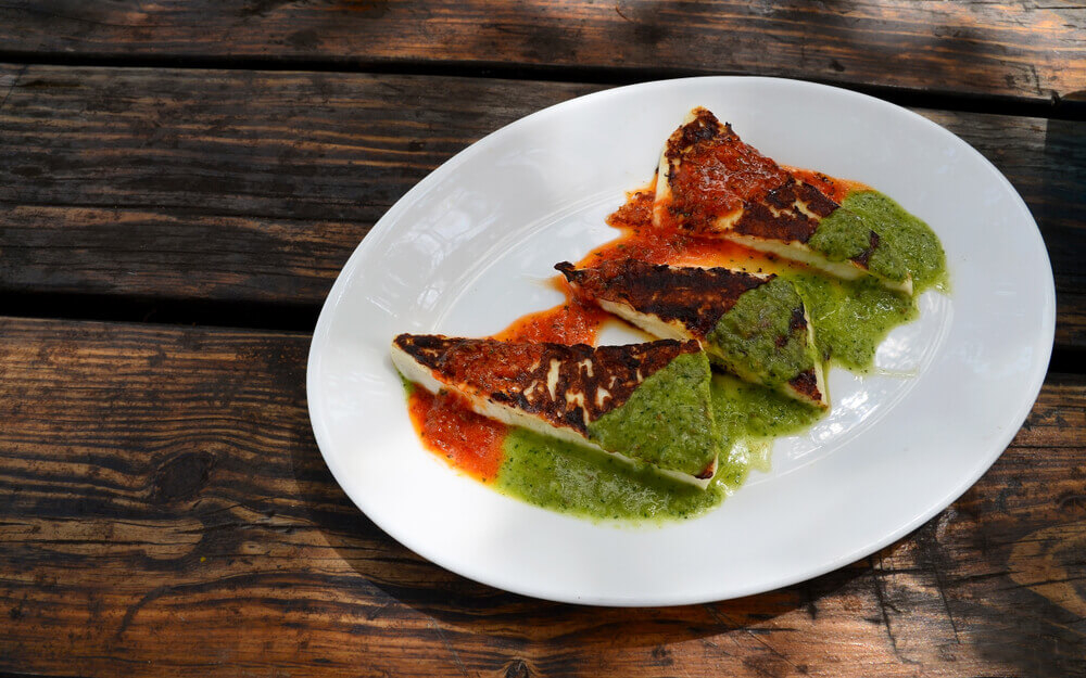 Canary Island food: A plate of grilled goat’s cheese served with red and green mojo sauce
