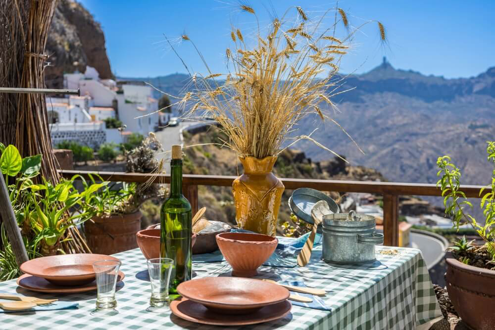 Canary Island Food: a green checked tablecloth and terracotta tableware in a Canarian restaurant 