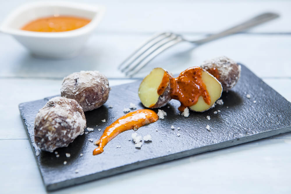 Papas Arrugadas: Wrinkled new potatoes covered in salt and red spicy sauce