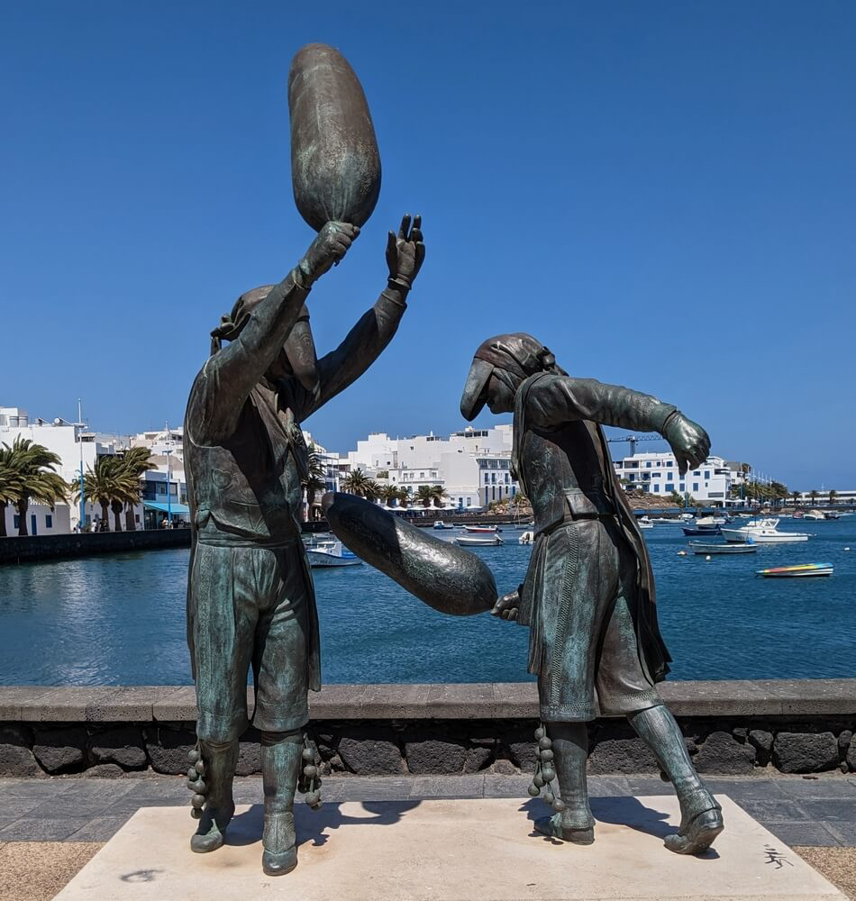 Lanzarote: A statue of two people dancing holding sacks