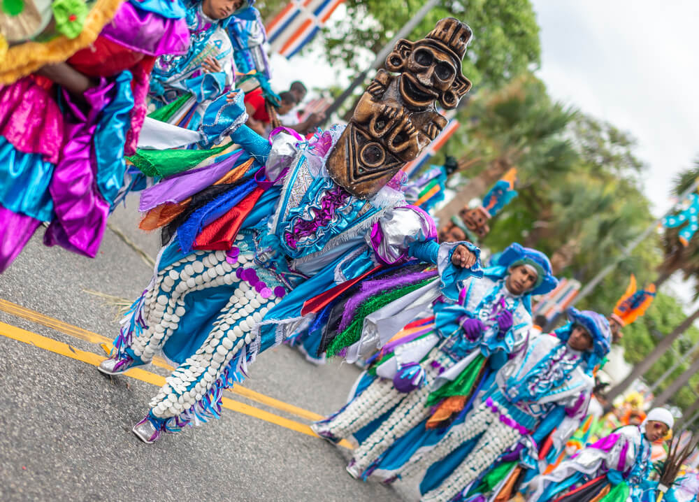 Los Guloyas: A group of men dressed in brightly coloured clothing and masks while dancing