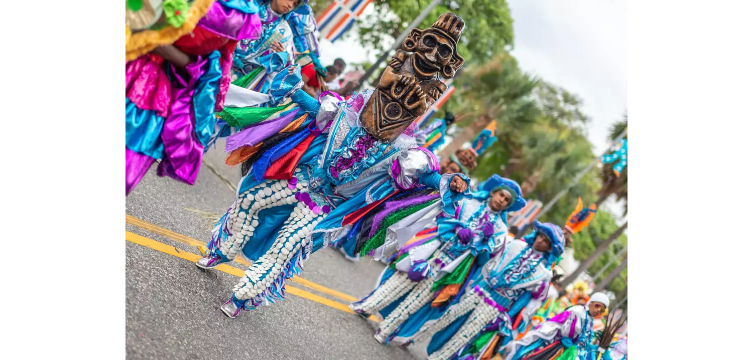 Los Guloyas: A group of men dressed in brightly coloured clothing and masks while dancing