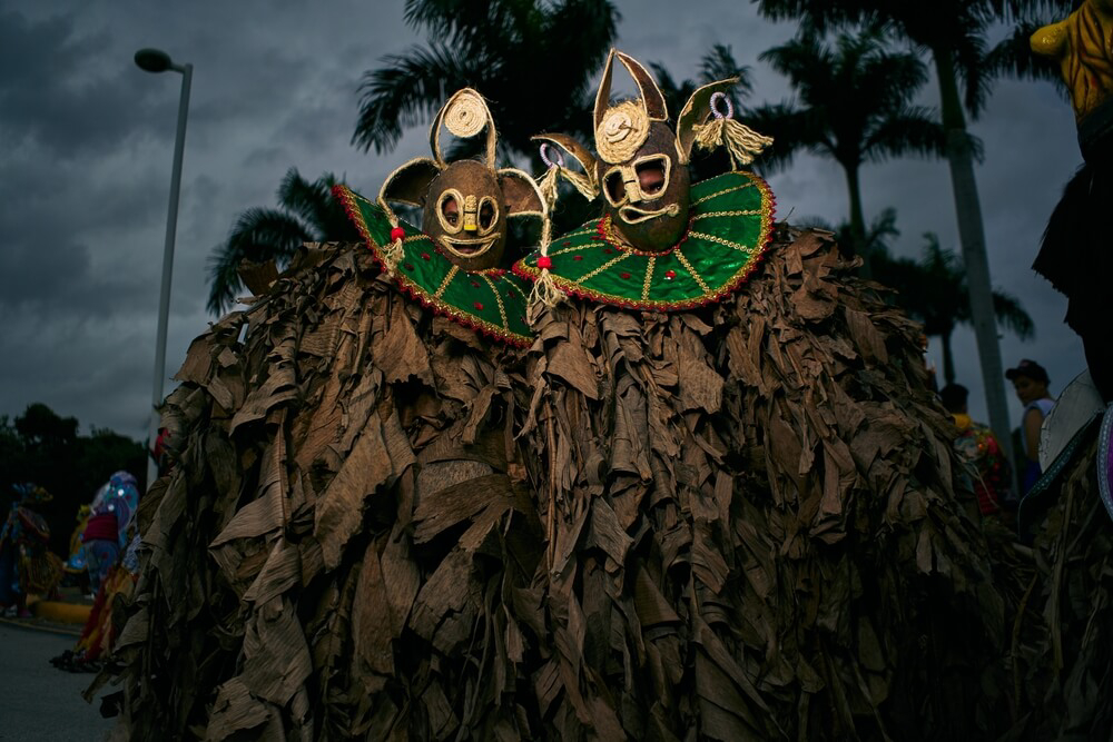 Punta Cana: A group of men dressed in brown robes with coconut masks