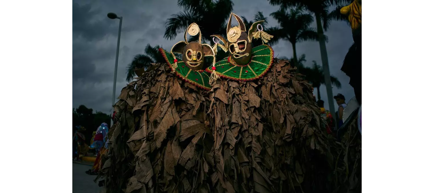Punta Cana: A group of men dressed in brown robes with coconut masks
