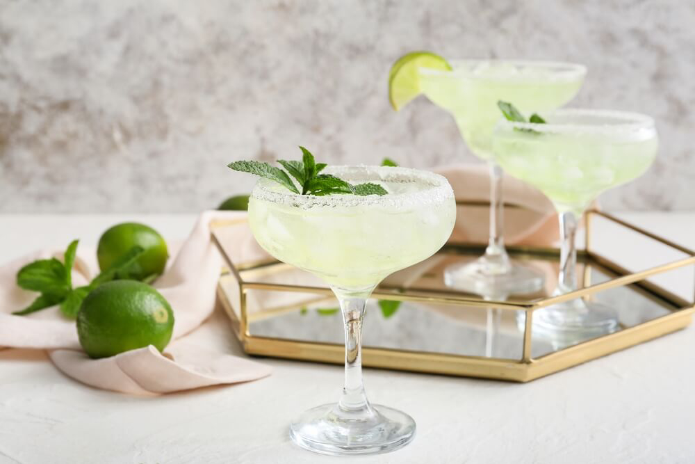 Caribbean Margarita: Three margarita cocktails with lime wedges