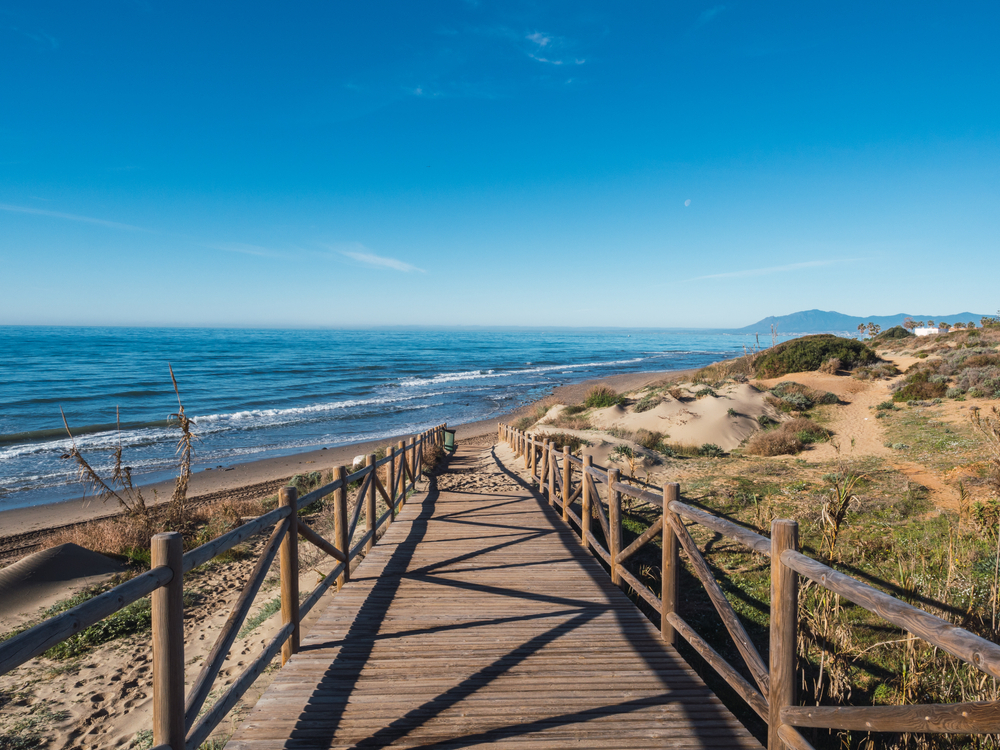 Costa del Sol Best Beaches: Wooden walkway leading to a sandy beach