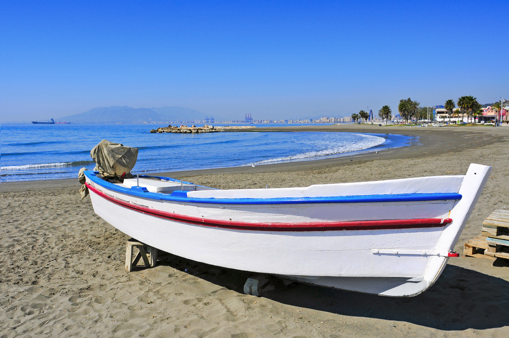 Pedregalejo: White sand beach and white fishing boat