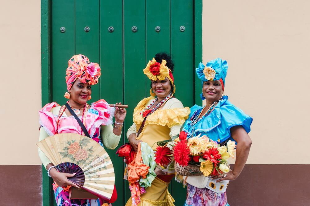 Afro-Caribbean: Three women dressed in colourful afro-caribbean clothing