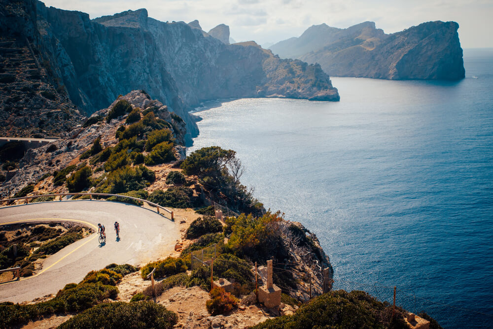 Cycling in Mallorca: Hair-pin bends on a mountain road being ridden by cyclists 