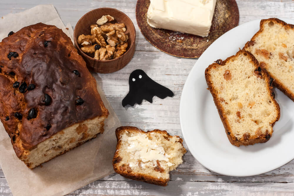 Irish Day of the Dead: A close up of Barm Brack cake with butter and walnuts