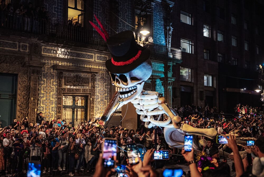 Day of the Dead in Mexico is celebrated by attending a night parade.