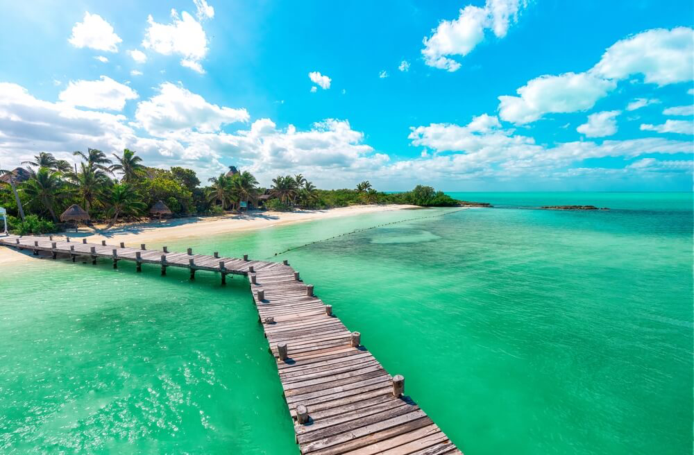 A wooden jetty off an idyllic beach on Isla Contoy, Mexico