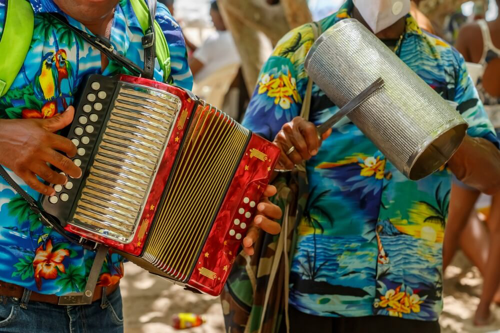 Aguinaldos: A close-up of two male musicians playing music in the street