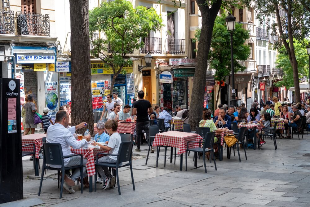 Easter in Madrid: A typical street in the Lacapiés neighbourhood with people sitting having a drink