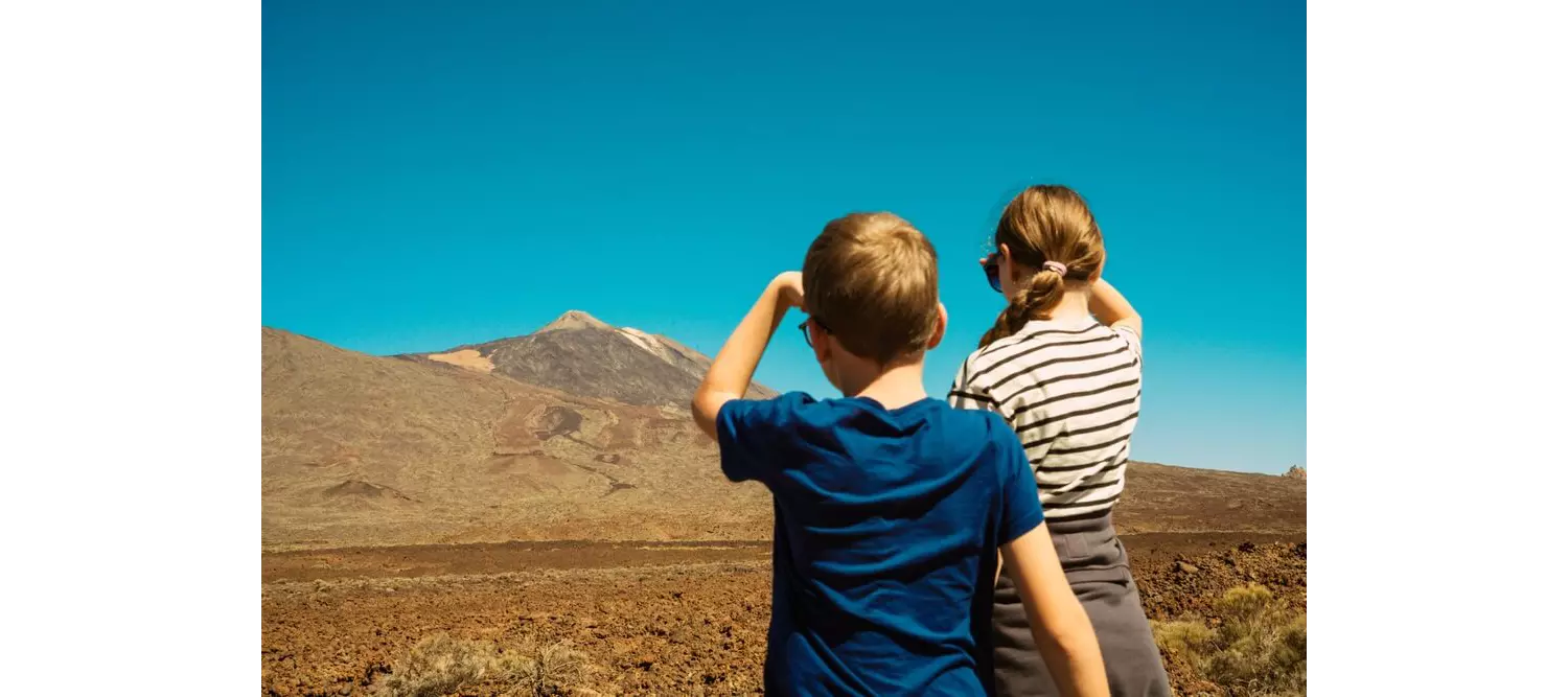 Family hiking holidays: Two children looking at El Teide volcano from a distance