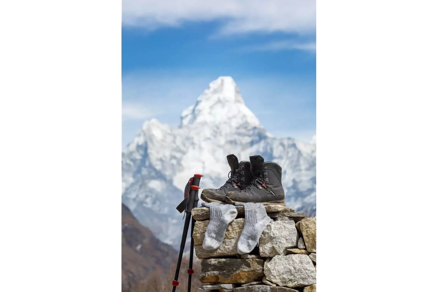 Family hiking holidays: Hiking boots and stick propped up on a wall