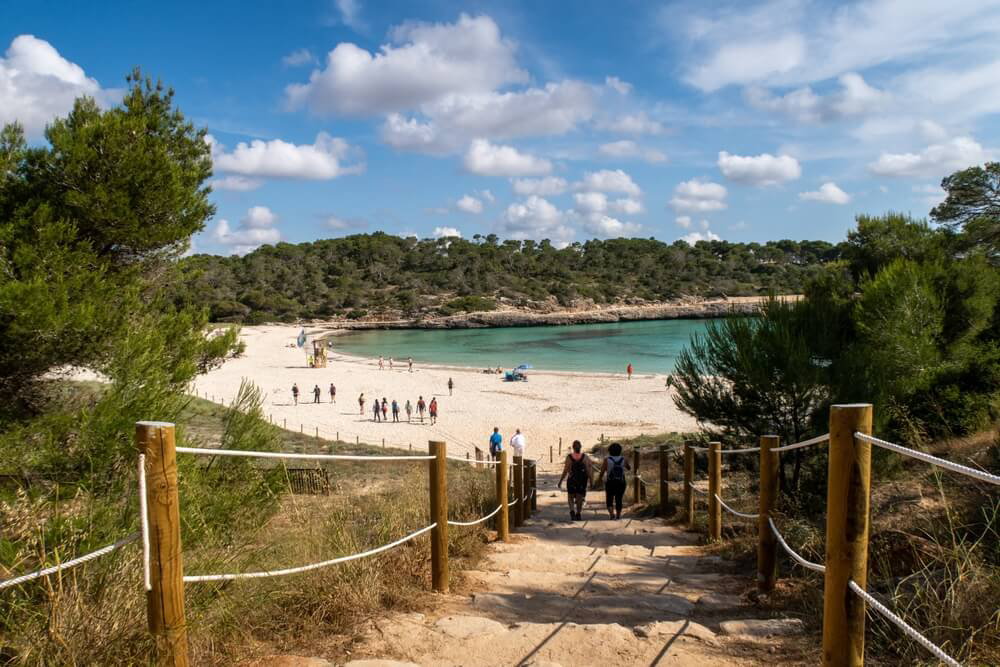 Mondragó Natural Park: A path with a white sand beach and topaz water