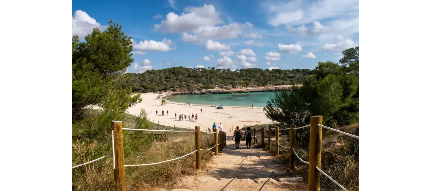 Mondragó Natural Park: A path with a white sand beach and topaz water