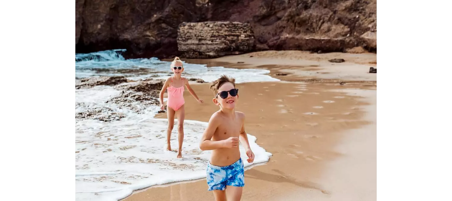Family holidays in Lanzarote: Two children playing on the golden sand beach