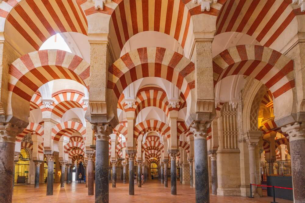 Mezquita: A close-up of the red and white arches inside the Mezquita in Córdoba