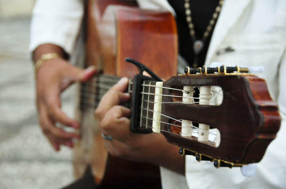 Flamenco shows in Madrid: A close-up of a man playing a Spanish guitar