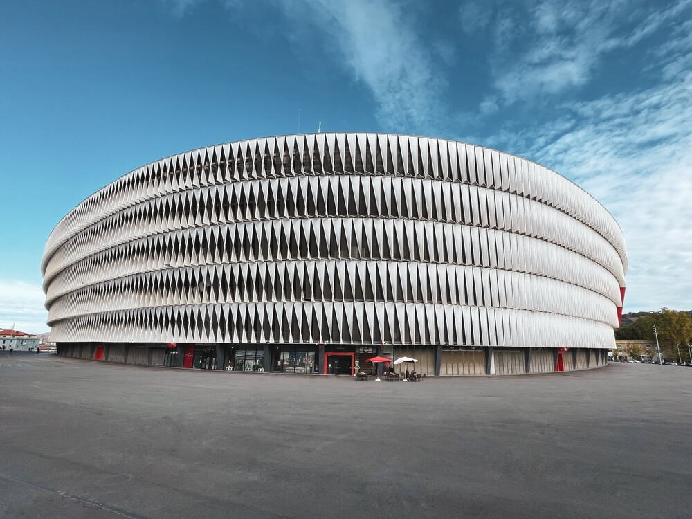 San Mamés: A circular, modern minimalist football stadium with red doors