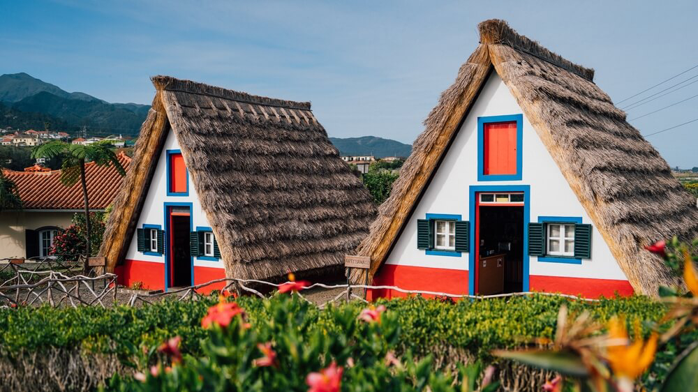 Friendship Day: Traditional houses in Madeira surrounded by greenery and mountains