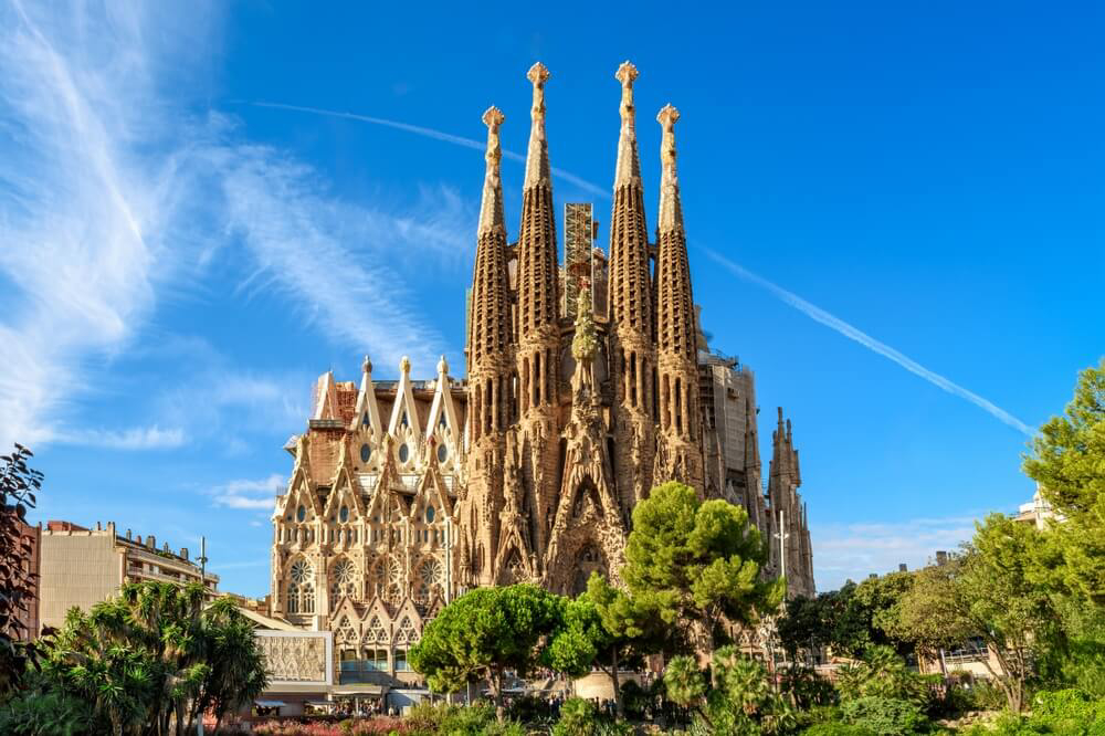 La Sagrada Familia: A view of the turreted sandstone church with its elaborate facade
