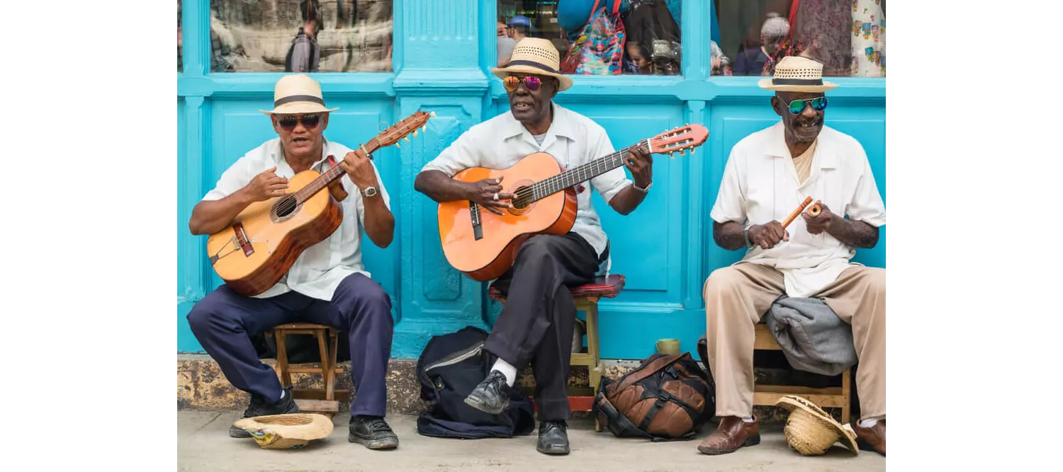 Hemingway Cuba: A close-up of three street musicians playing instruments in Havana, Cuba