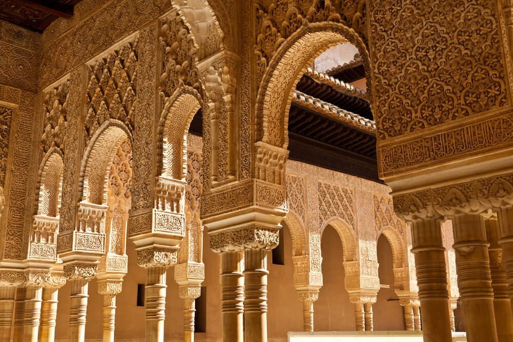 Visiting the Alhambra Granada: A close-up of the detailed arches in the Court of Lions