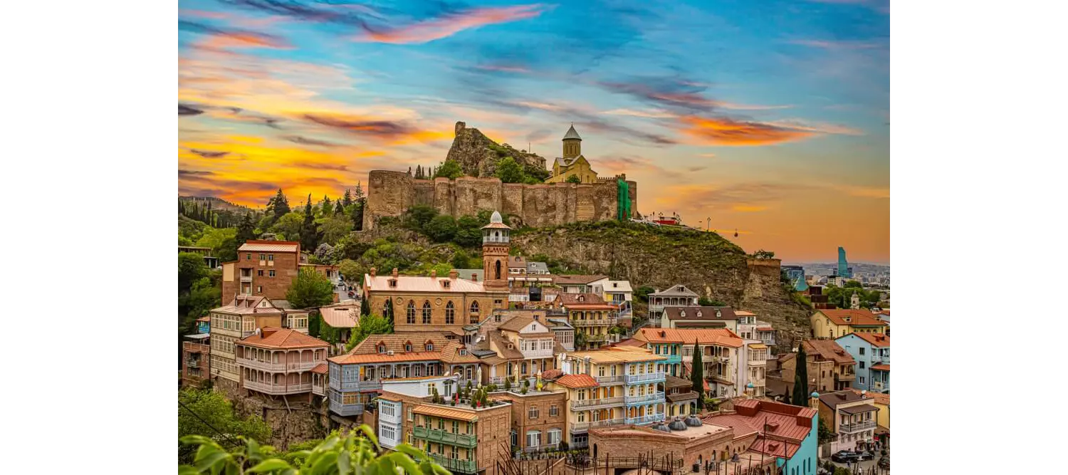Fortress: Sunset over the hills with a fort on top of them