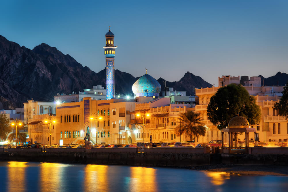 Holidays to Oman: The Muttrah Corniche illuminated at sunset next to the sea