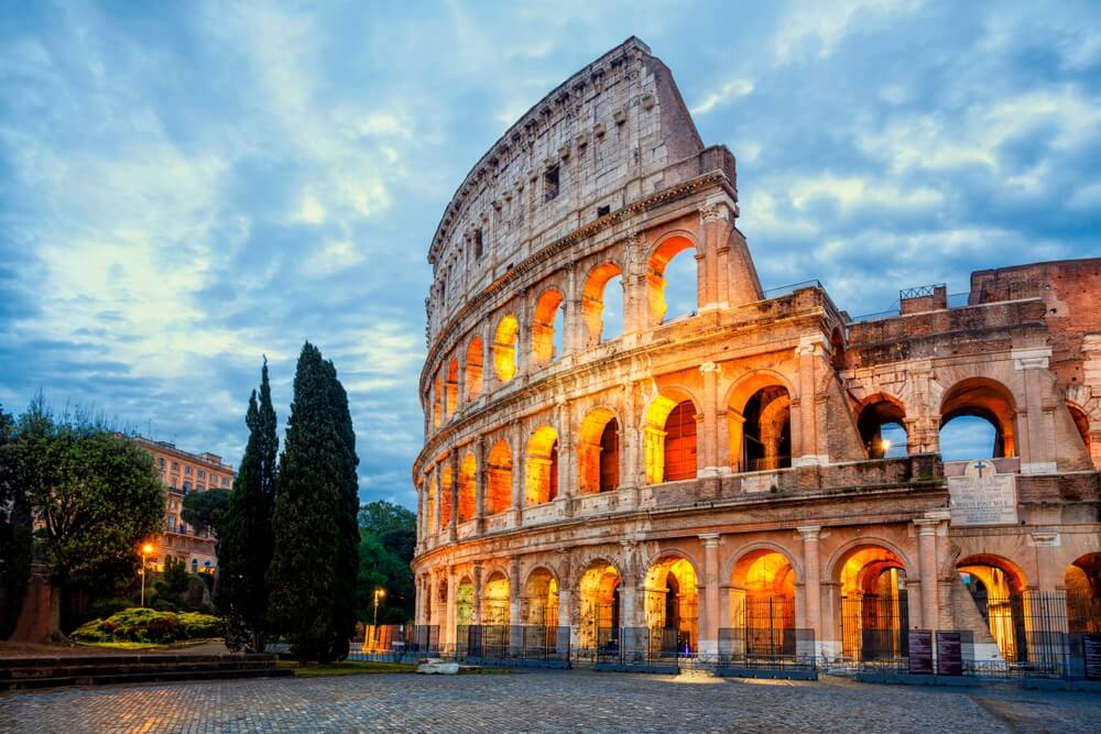 Instagrammable locations: A side view of the Colosseum in Rome lit up at night